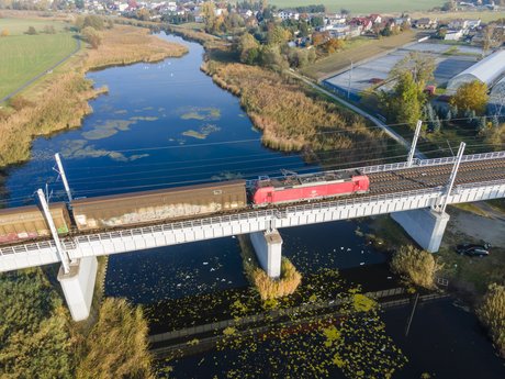 Train on the bridge crossing the river.